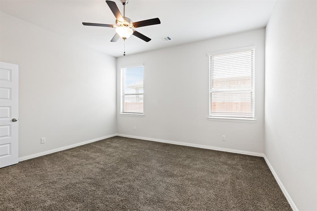 4149 Beale Street Heartland, TX 75114 - Photo 12 of 27 an empty room with windows and fan