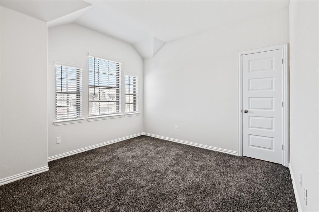 4149 Beale Street Heartland, TX 75114 - Photo 18 of 27 an empty room with windows