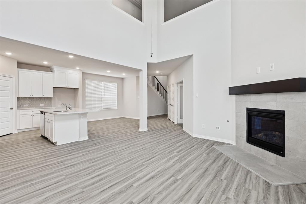 4149 Beale Street Heartland, TX 75114 - Photo 7 of 27 a view of kitchen with granite countertop cabinets and wooden floor