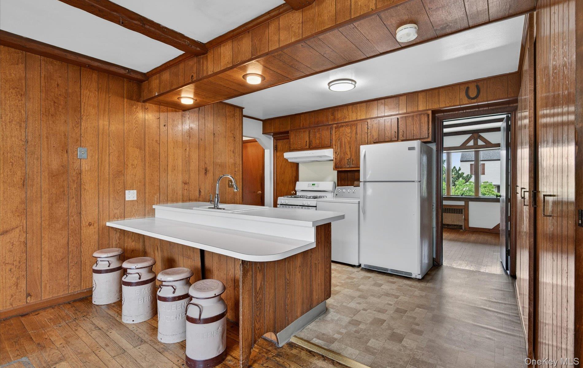 24 Purdue Road Glen Cove, NY 11542 - Photo 18 of 41 a kitchen with a refrigerator and a table
