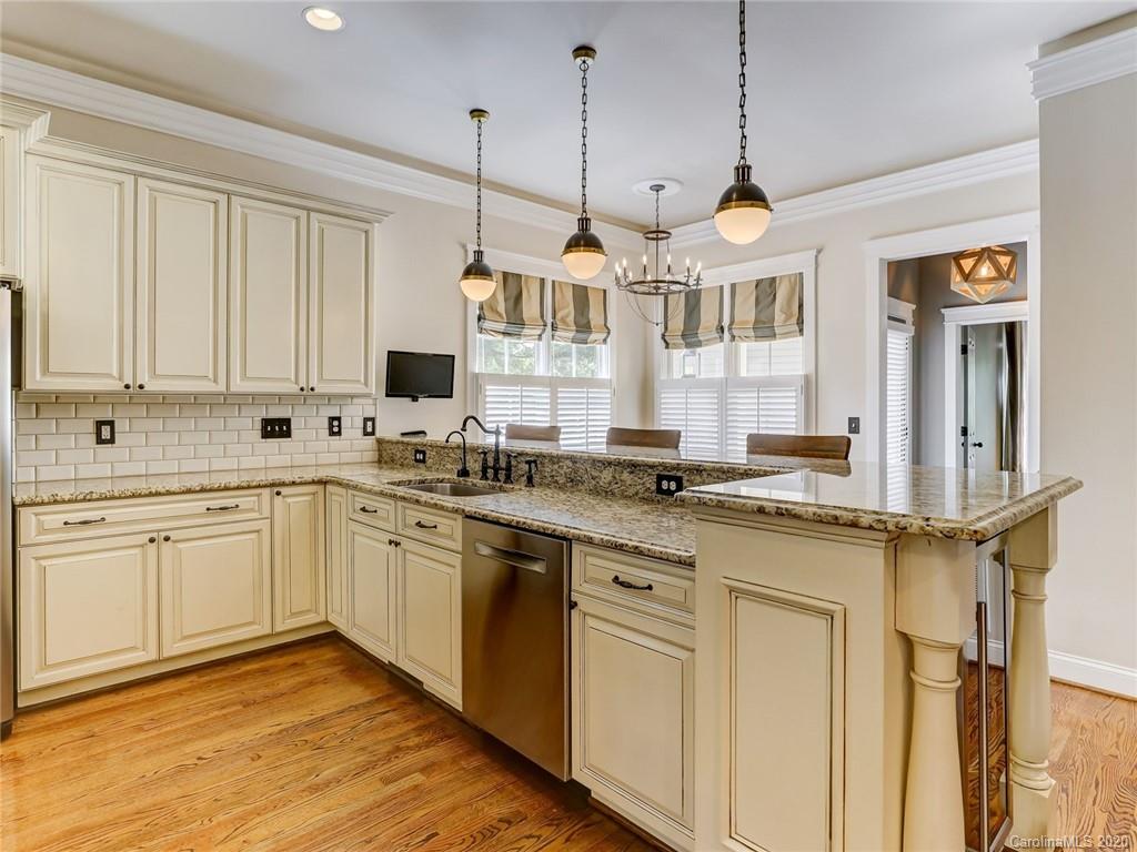317 Third Baxter Street Fort Mill, SC 29708 - Photo 16 of 48 a kitchen with stainless steel appliances granite countertop a stove a sink and white cabinets