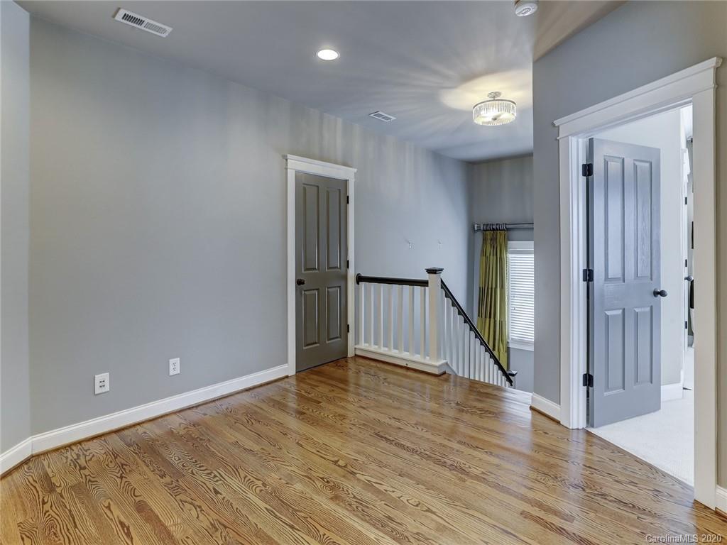 317 Third Baxter Street Fort Mill, SC 29708 - Photo 33 of 48 a view of an empty room with wooden floor and a window