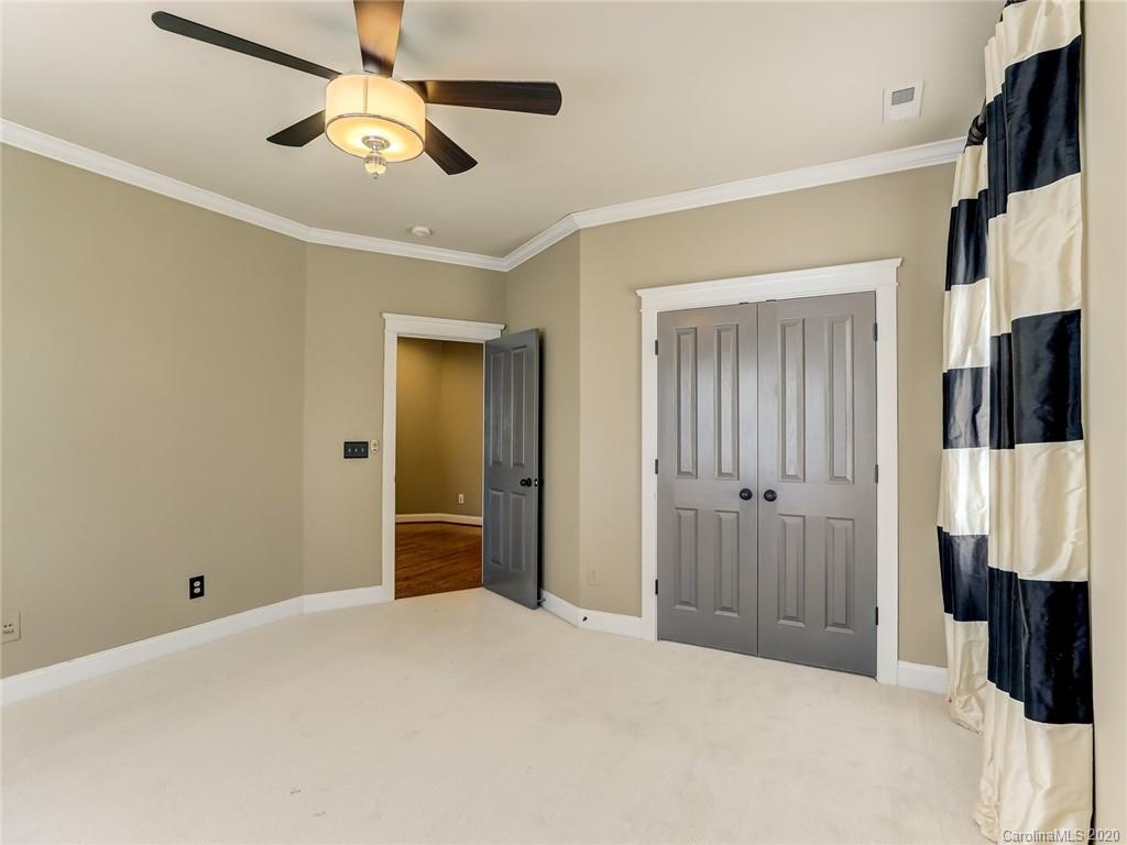317 Third Baxter Street Fort Mill, SC 29708 - Photo 36 of 48 a bedroom with a bed and a flat tv screen on dresser