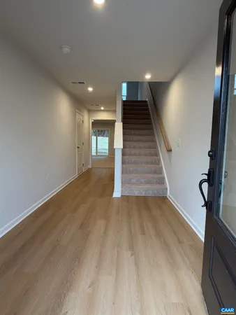 a view of entryway and hall with wooden floor
