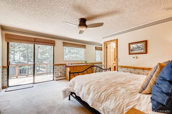 501 Peakview Road Boulder, CO 80302 - Photo 11 of 40 a bedroom with a large bed and a large window