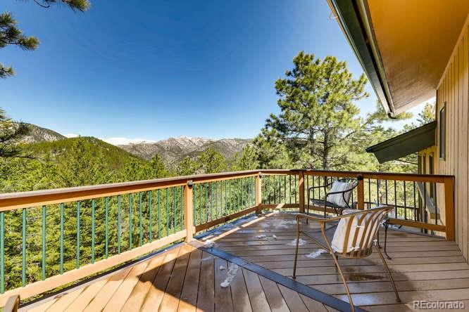 501 Peakview Road Boulder, CO 80302 - Photo 25 of 40 a view of a balcony with wooden floor and outdoor seating
