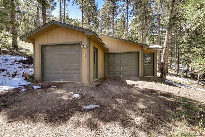 501 Peakview Road Boulder, CO 80302 - Photo 29 of 40 a front view of a house with a yard and garage
