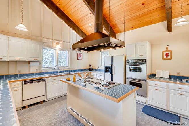 501 Peakview Road Boulder, CO 80302 - Photo 5 of 40 a kitchen with a stove and a white refrigerator