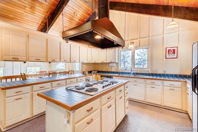 501 Peakview Road Boulder, CO 80302 - Photo 6 of 40 a kitchen with stainless steel appliances granite countertop a sink a stove and cabinets