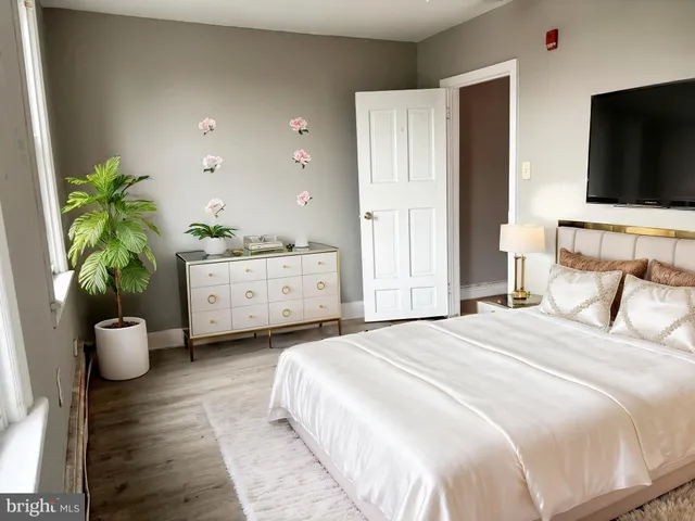 a bedroom with a bed and a flat screen tv