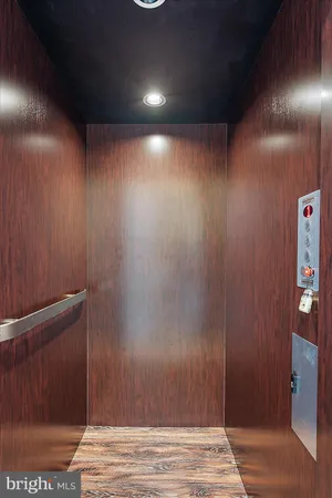 a dining hall with stainless steel appliances granite countertop a sink dishwasher a dining table and chairs with wooden floor