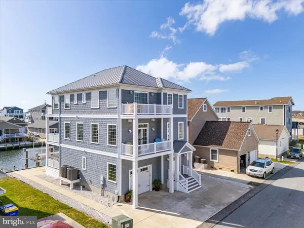 a view of a hallway with entryway wooden floor and front door