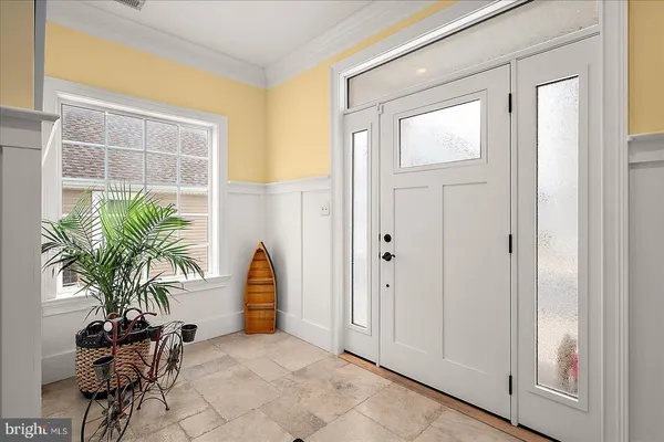 a living room with furniture a large window and wooden floor