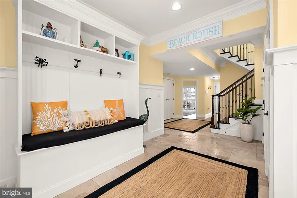 a kitchen with stainless steel appliances granite countertop a sink a stove a refrigerator cabinets and a dining table