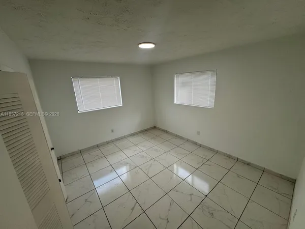 a kitchen with sink refrigerator and window