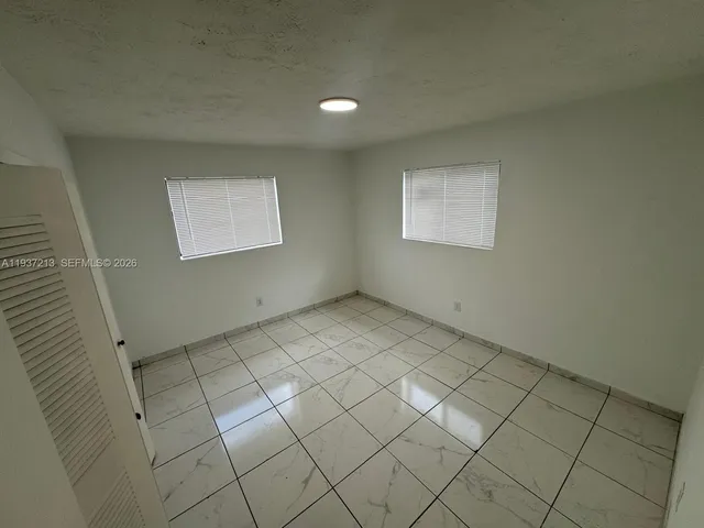 a kitchen with sink refrigerator and window