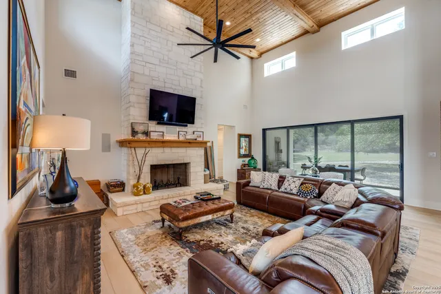 a living room with furniture and a floor to ceiling window