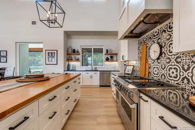 a kitchen with stainless steel appliances a sink dishwasher stove and refrigerator