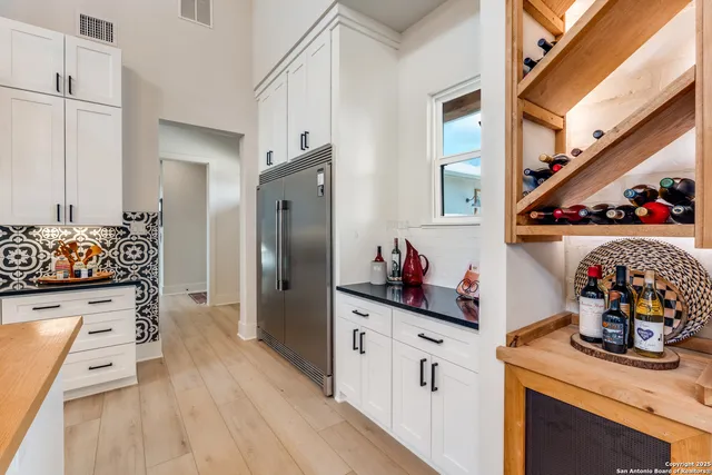 a kitchen with stainless steel appliances granite countertop a stove and cabinets