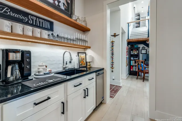 a living room with lots of furniture and stairs