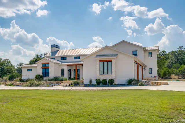 a front view of a house with swimming pool having outdoor seating