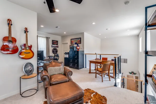 a living room with furniture and a book shelf