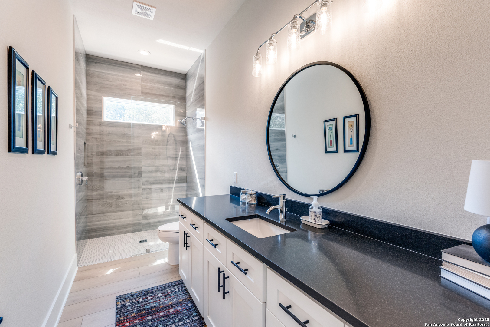 130 Saga Street Spring Branch, TX 78070 - Photo 36 of 49 a bathroom with a double vanity sink and a mirror