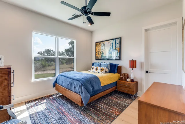 a bathroom with a granite countertop sink a mirror and shower