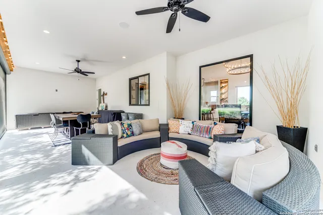 a view of a dining room with furniture and a chandelier