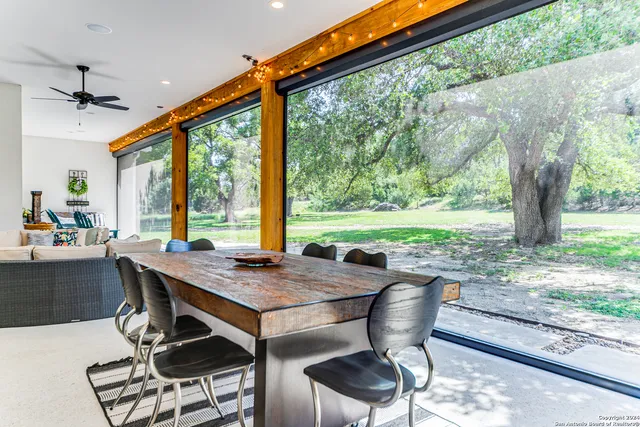 a living room with patio furniture and a large window