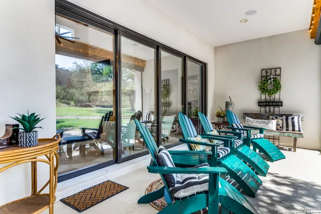a view of a dining room with furniture a chandelier and wooden floor