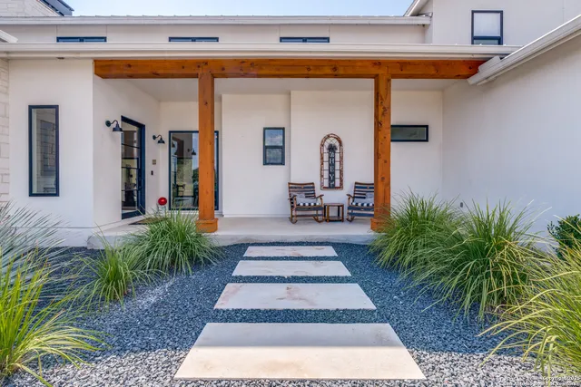 a view of a hallway with wooden floor and windows