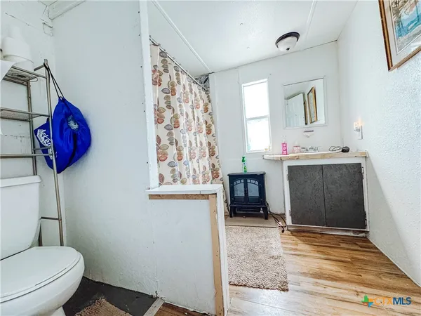 a bathroom with a toilet sink and mirror