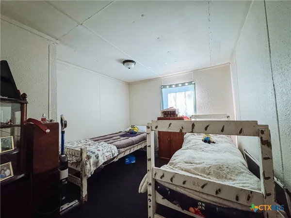 a bedroom with furniture and a window