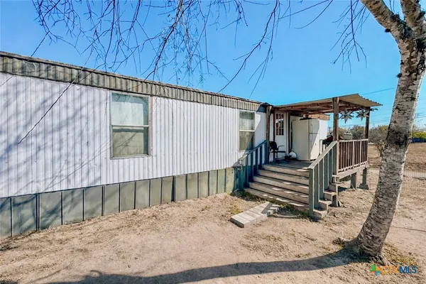 a view of a backyard with wooden fence