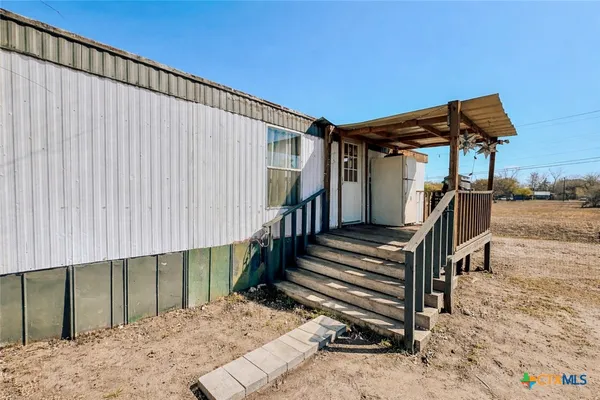a view of a backyard with a small cabin