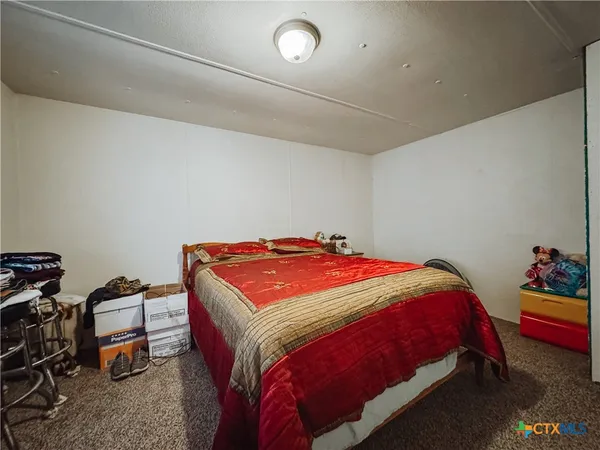 a bedroom with a bed and a dresser in it