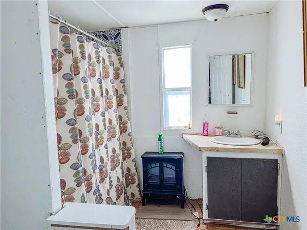 a bathroom with a sink and a mirror
