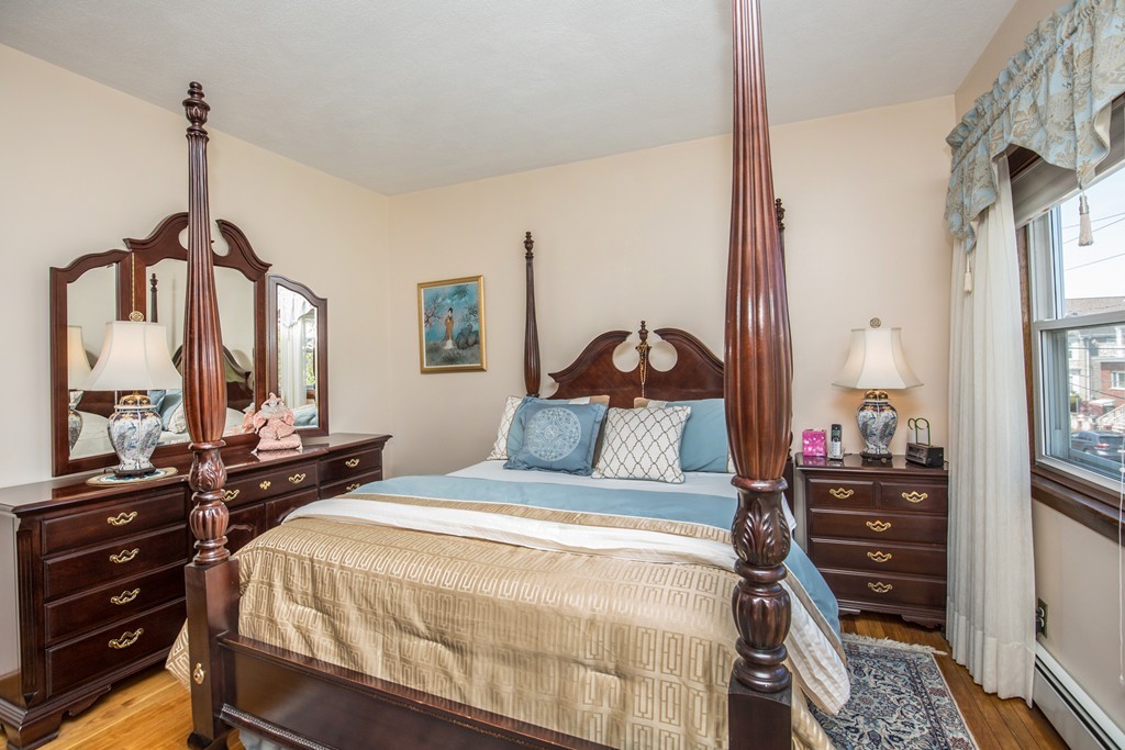 35 Winthrop Street Everett, MA 02149 - Photo 17 of 30 a bedroom with a bed and wooden floor