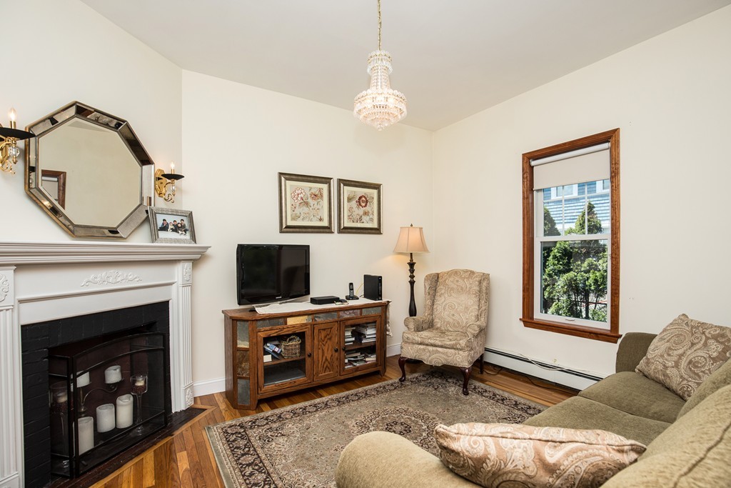 35 Winthrop Street Everett, MA 02149 - Photo 22 of 30 a living room with furniture a fireplace and a window