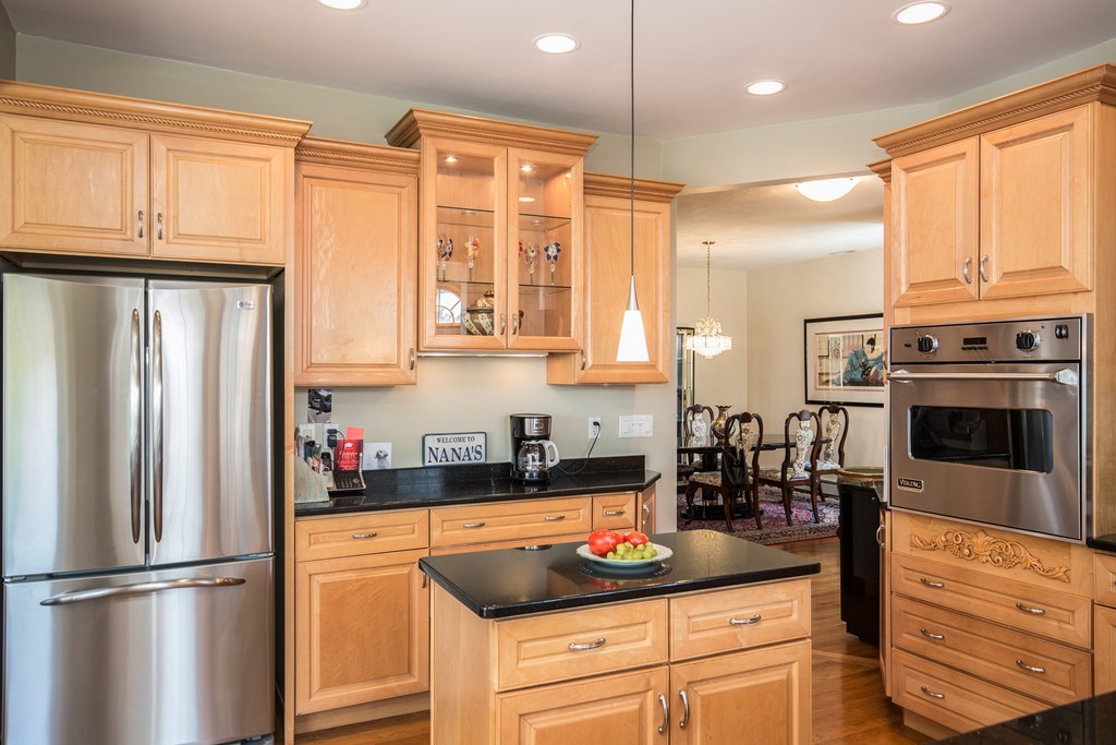 35 Winthrop Street Everett, MA 02149 - Photo 6 of 30 a kitchen with stainless steel appliances granite countertop a refrigerator a stove and a sink with wooden cabinets