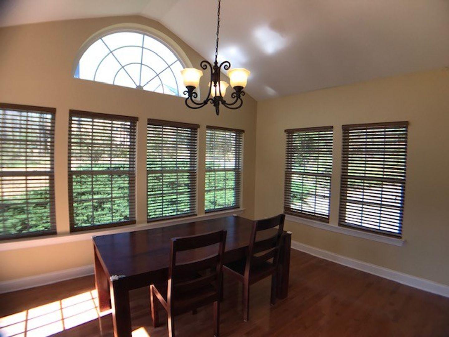 1120 Riggins Mill Road Cary, NC 27519 - Photo 14 of 34 a view of a dining room with furniture window and wooden floor