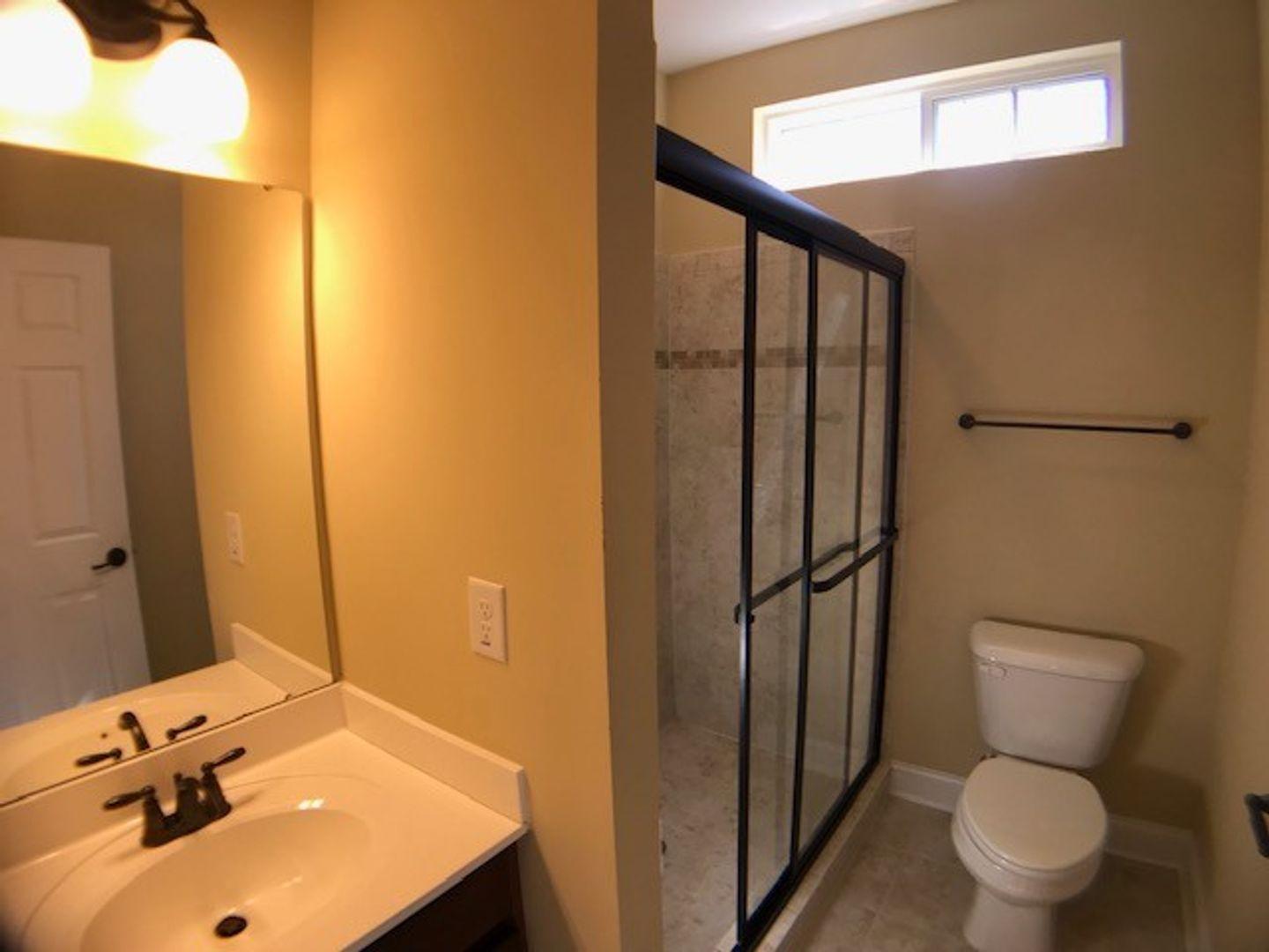 1120 Riggins Mill Road Cary, NC 27519 - Photo 18 of 34 a bathroom with a sink toilet and shower