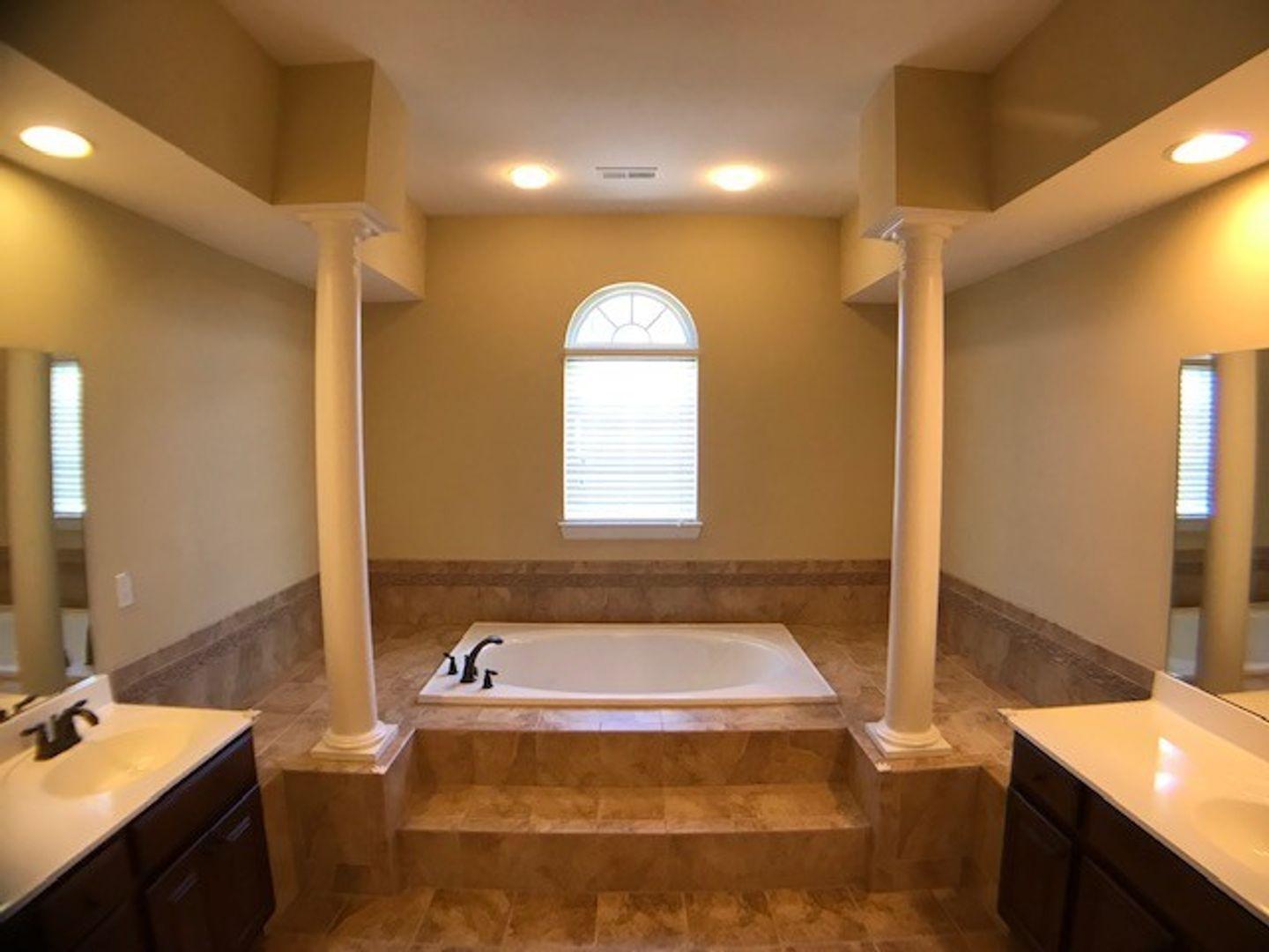 1120 Riggins Mill Road Cary, NC 27519 - Photo 29 of 34 a bathroom with a tub sink and mirror