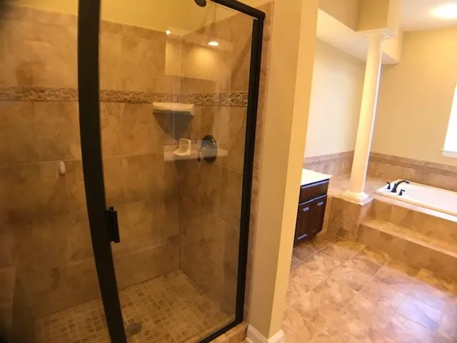 a bathroom with a bathtub and a shower