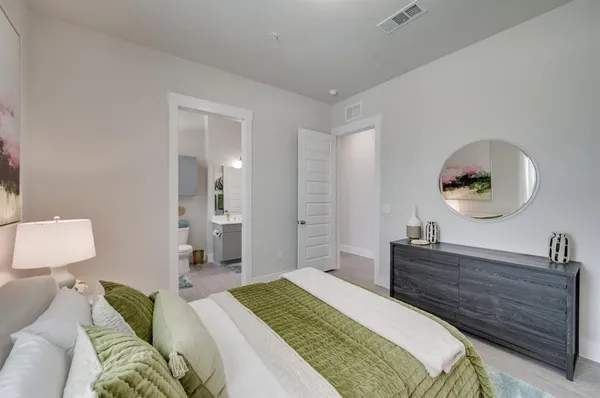 a bedroom with a bed and a dresser
