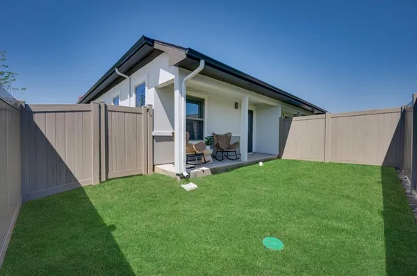 a view of a house with backyard and porch