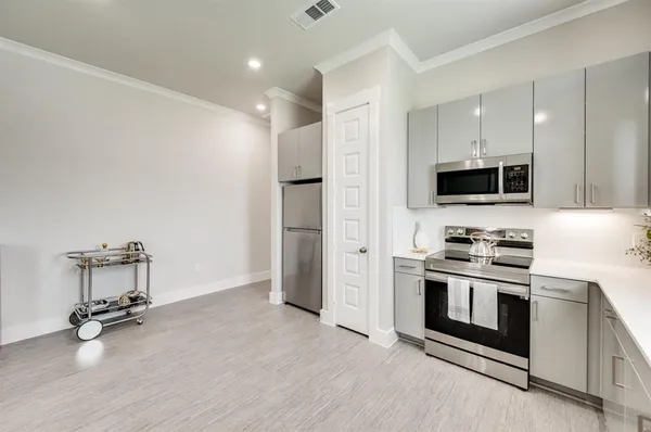 a kitchen with a stove a sink and a refrigerator