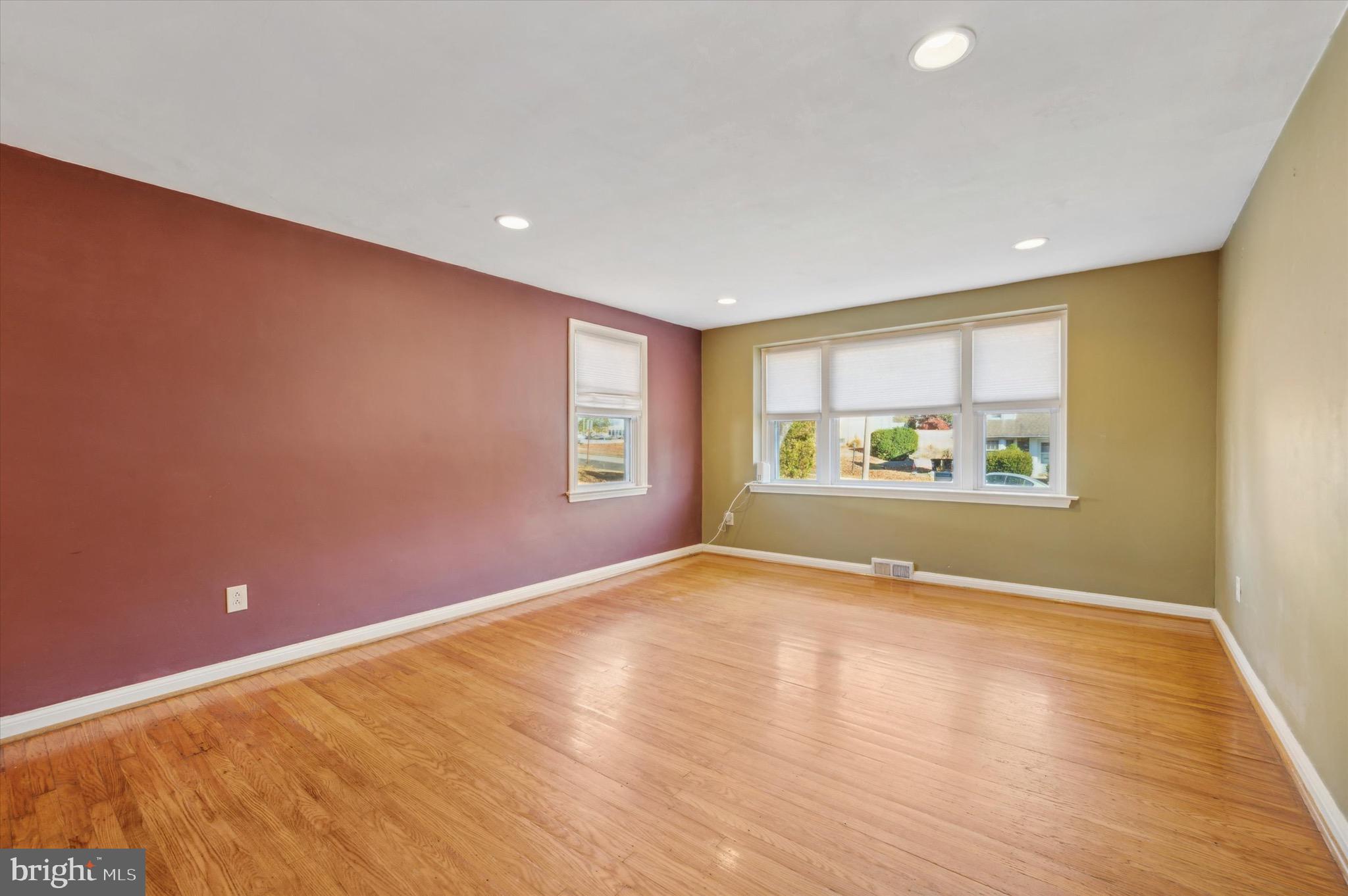 222 Fairhill Road Morton, PA 19070 - Photo 8 of 40 a view of an empty room with a window and wooden floor