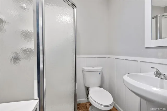 a white toilet sitting next to a bathroom sink